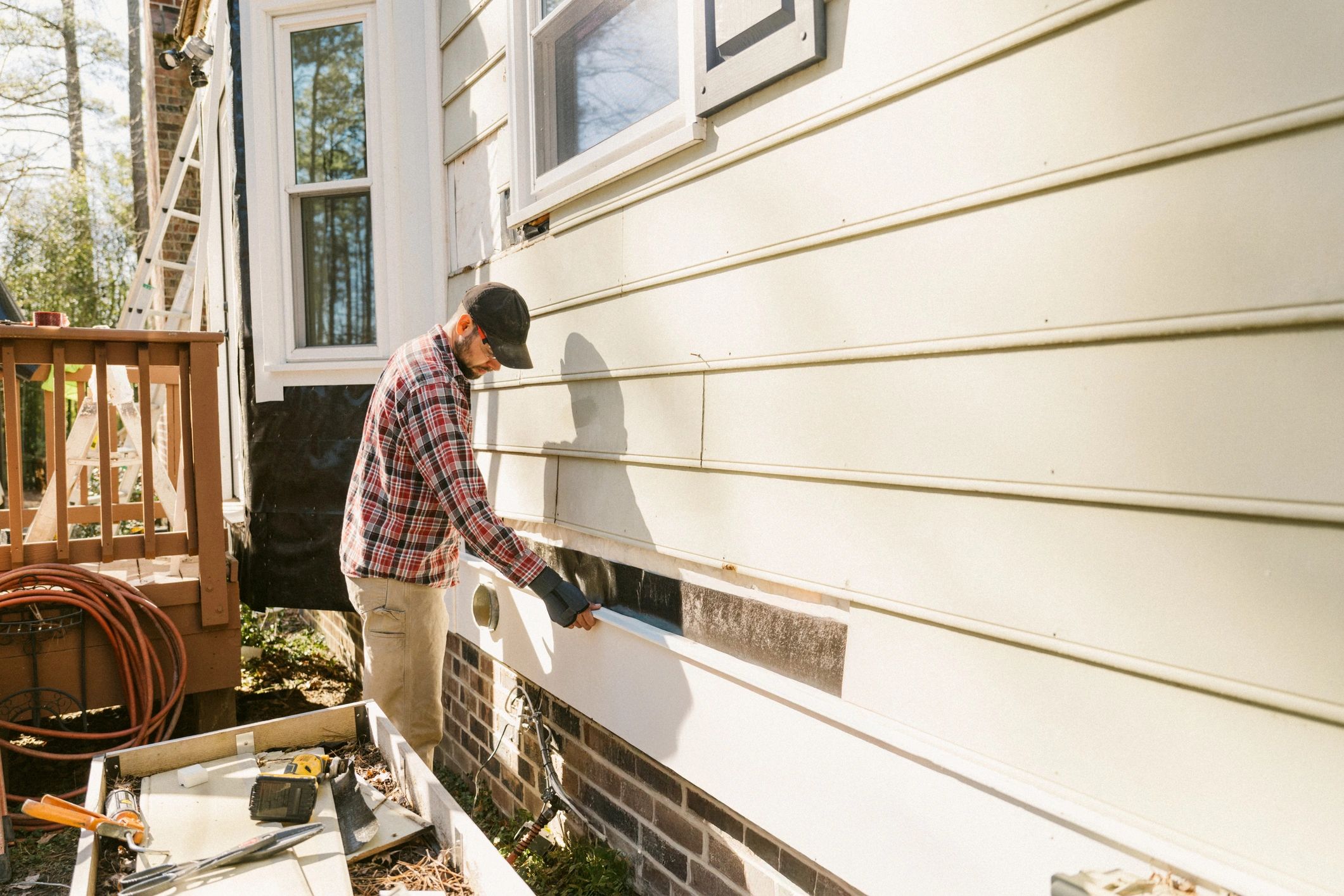 Technician working on an exterior installation at a residential property