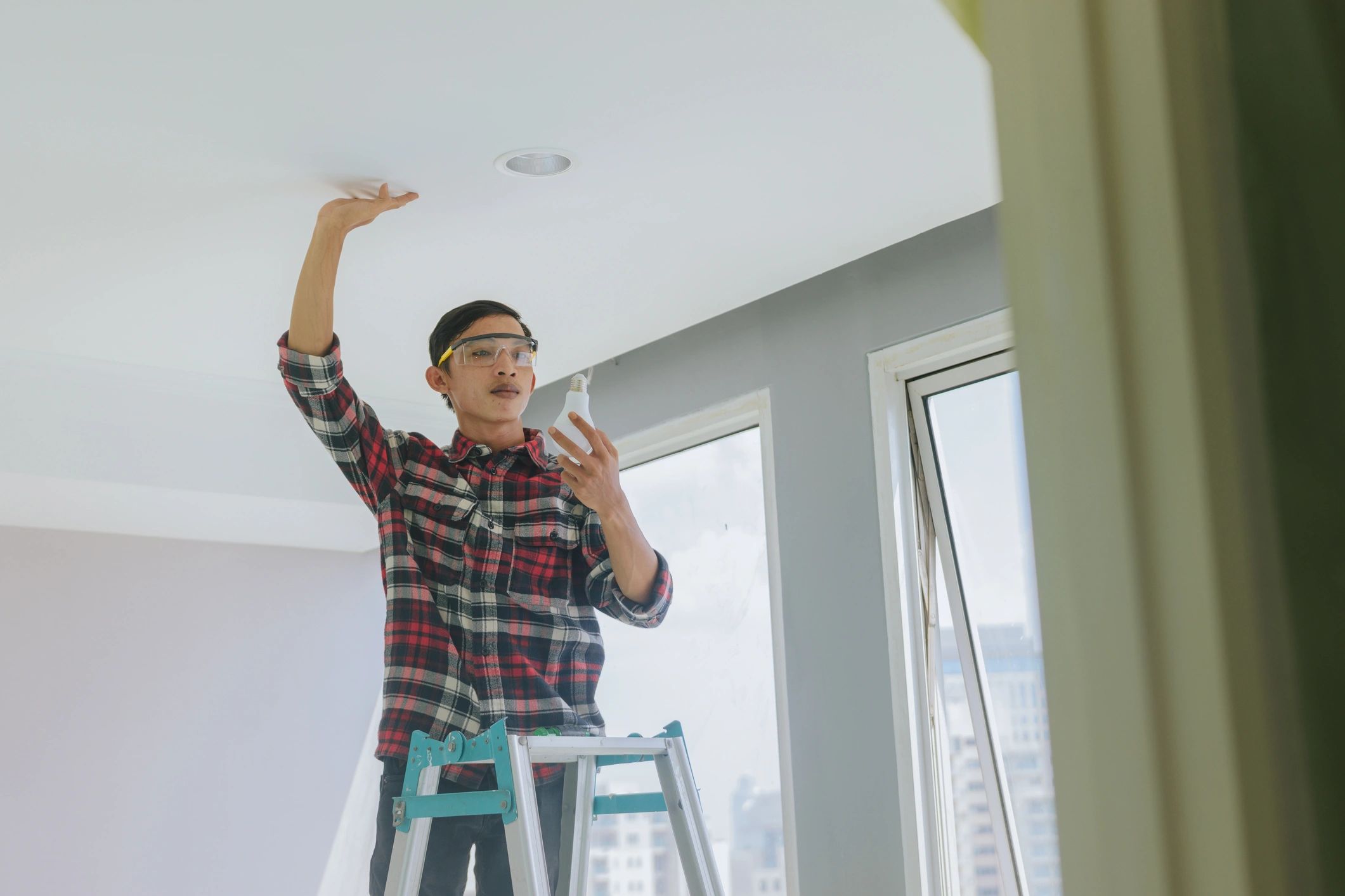 Technician performing installation and service work inside a modern property